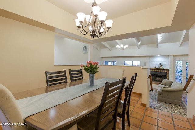 2000 E Campbell Ter, Tucson, AZ 85718 - tiled dining area featuring a chandelier, a brick fireplace, and beamed ceiling