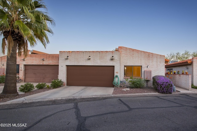 2000 E Campbell Ter, Tucson, AZ 85718 - view of front of home featuring concrete driveway and an attached garage