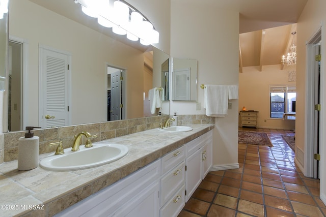 2000 E Campbell Ter, Tucson, AZ 85718 - bathroom featuring double vanity, a chandelier, tile patterned flooring, a closet, and a towering ceiling