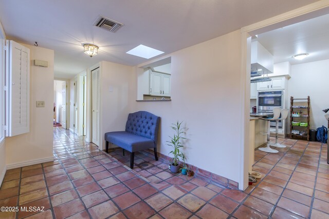 2000 E Campbell Ter, Tucson, AZ 85718 - hallway featuring a skylight and baseboards