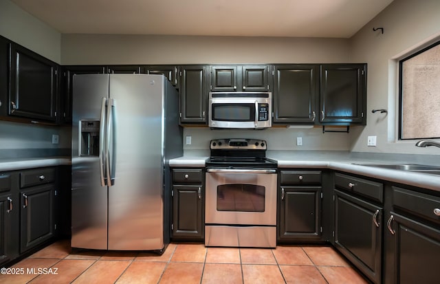 2990 W Trevi Pl Unit 200, Tucson, AZ 85741 - kitchen with stainless steel appliances, light countertops, and light tile patterned floors
