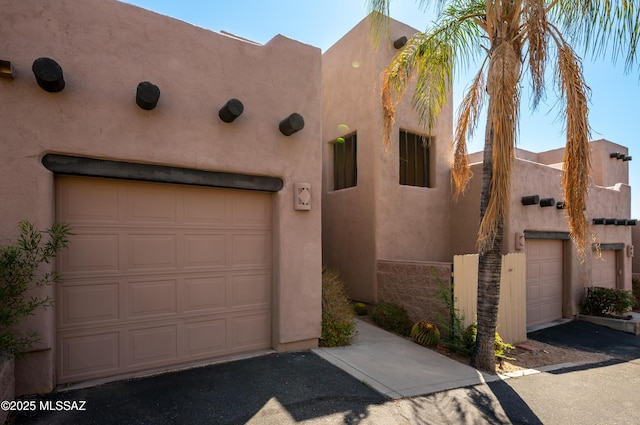2990 W Trevi Pl Unit 200, Tucson, AZ 85741 - pueblo-style house with a garage and stucco siding