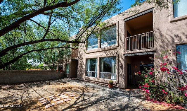 2990 W Trevi Pl Unit 200, Tucson, AZ 85741 - rear view of house featuring stucco siding and a balcony