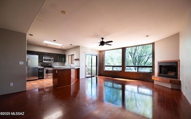 2990 W Trevi Pl Unit 200, Tucson, AZ 85741 - kitchen featuring appliances with stainless steel finishes, open floor plan, light wood-type flooring, and light countertops