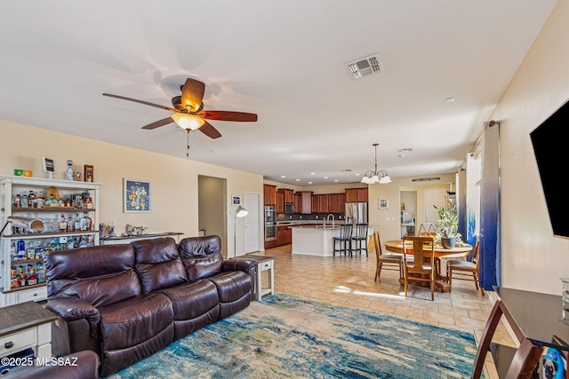 10235 E Placita De Dos Pesos, Tucson, AZ 85730 - living room with a ceiling fan, a chandelier, recessed lighting, and light tile patterned floors