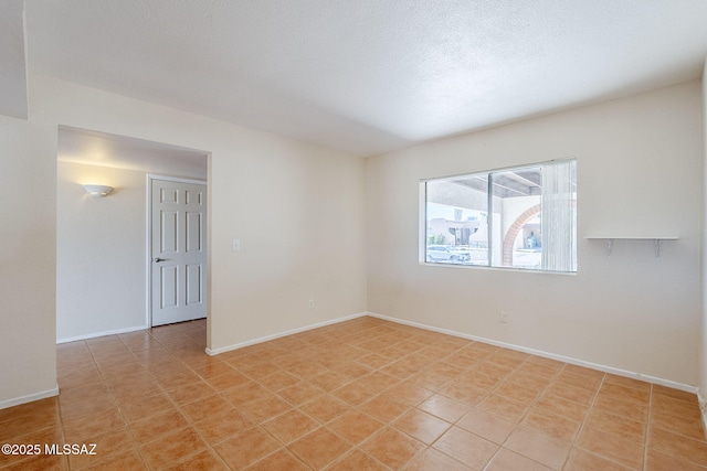 2366 N Camino Mateo, Tucson, AZ 85745 - unfurnished room featuring baseboards