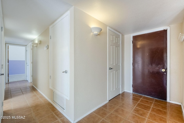2366 N Camino Mateo, Tucson, AZ 85745 - hallway featuring light tile patterned floors