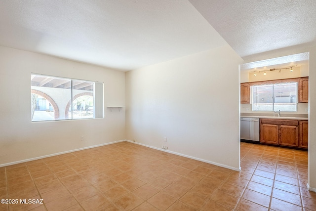 2366 N Camino Mateo, Tucson, AZ 85745 - unfurnished room featuring light tile patterned flooring and a textured ceiling