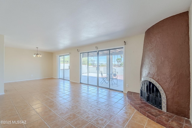 2366 N Camino Mateo, Tucson, AZ 85745 - unfurnished living room featuring a chandelier, light tile patterned flooring, and a large fireplace