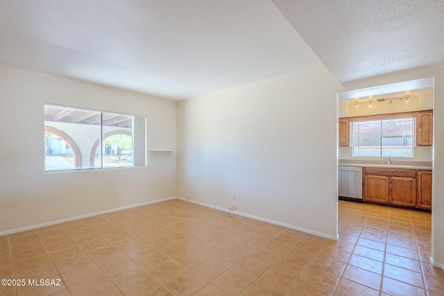 2366 N Camino Mateo, Tucson, AZ 85745 - unfurnished room with light tile patterned floors and a textured ceiling