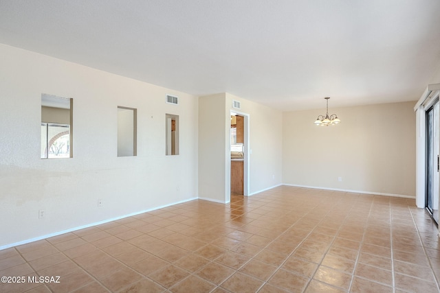 2366 N Camino Mateo, Tucson, AZ 85745 - spare room with a chandelier and light tile patterned floors