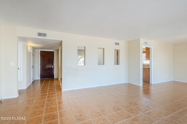 2366 N Camino Mateo, Tucson, AZ 85745 - empty room featuring light tile patterned floors and baseboards