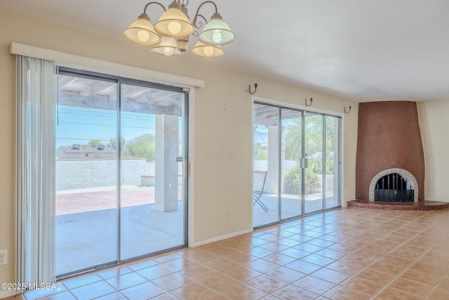 2366 N Camino Mateo, Tucson, AZ 85745 - unfurnished living room with a chandelier, light tile patterned floors, and a fireplace