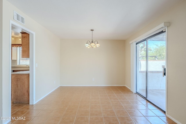 2366 N Camino Mateo, Tucson, AZ 85745 - unfurnished room featuring a chandelier and light tile patterned floors