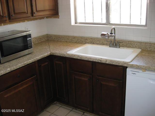 3885 W Mars St, Tucson, AZ 85741 - kitchen featuring stainless steel microwave, dishwasher, light countertops, and backsplash
