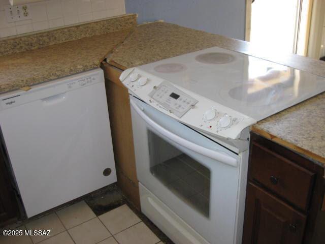 3885 W Mars St, Tucson, AZ 85741 - kitchen featuring white appliances, light tile patterned floors, light countertops, and backsplash