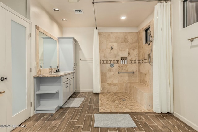 6859 N Placita Chula Vis, Tucson, AZ 85704 - bathroom with wood tiled floors, tiled shower, vanity, and recessed lighting