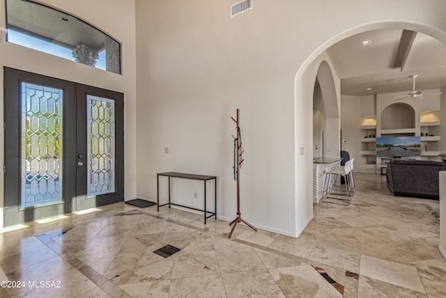 6859 N Placita Chula Vis, Tucson, AZ 85704 - foyer entrance featuring french doors, ceiling fan, arched walkways, a high ceiling, and marble finish floors
