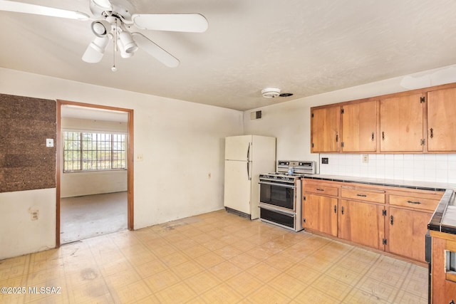 202 E Jacinto St, Tucson, AZ 85705 - kitchen featuring gas stove, freestanding refrigerator, light floors, ceiling fan, and tile counters