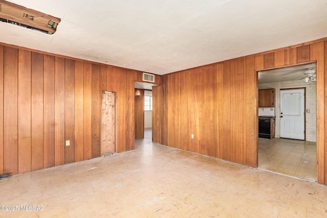 202 E Jacinto St, Tucson, AZ 85705 - spare room with wood walls and a ceiling fan