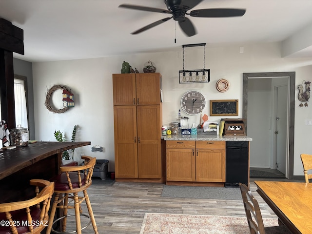 7855 N Northern Ave, Tucson, AZ 85704 - kitchen featuring light wood-type flooring, ceiling fan, brown cabinets, and light stone counters