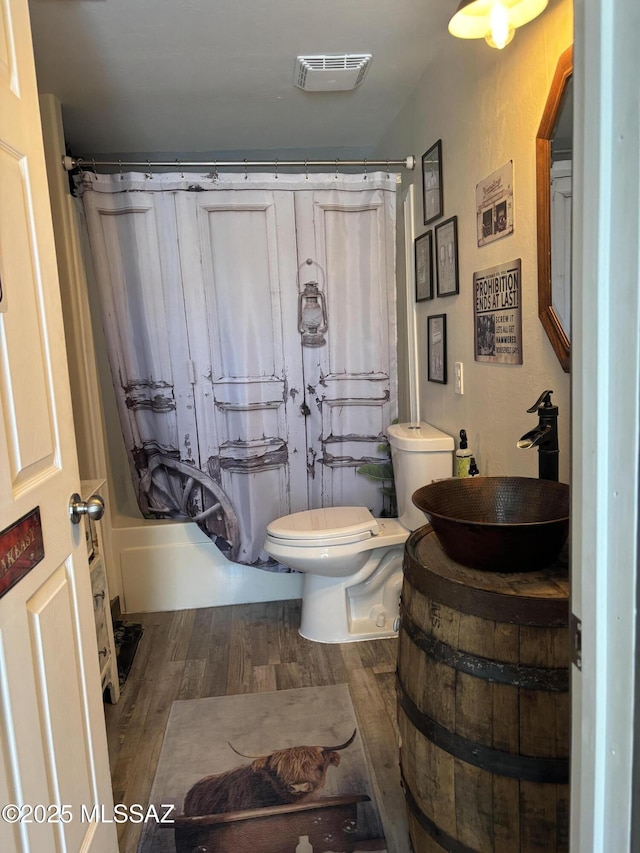 7855 N Northern Ave, Tucson, AZ 85704 - bathroom featuring wood finished floors, shower / bath combo with shower curtain, and vanity