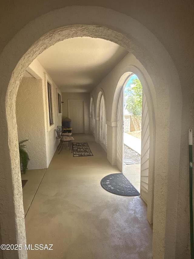 7855 N Northern Ave, Tucson, AZ 85704 - hallway with a textured wall, arched walkways, and carpet