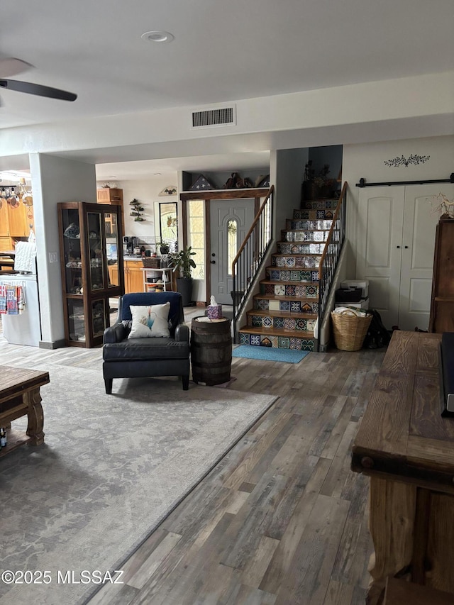 7855 N Northern Ave, Tucson, AZ 85704 - living area featuring wood finished floors, stairway, and a ceiling fan