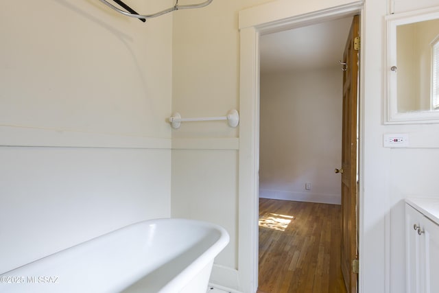 642 E 2nd St, Tucson, AZ 85705 - bathroom featuring a freestanding bath and wood finished floors