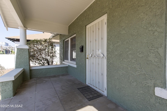 642 E 2nd St, Tucson, AZ 85705 - property entrance with stucco siding and covered porch