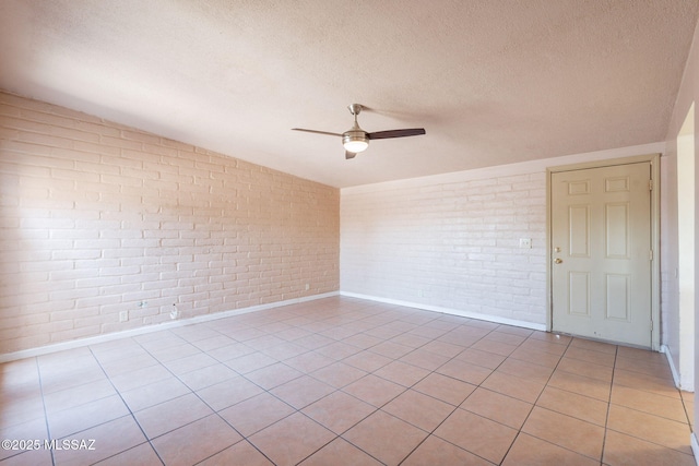325 W Santa Maria St, Tucson, AZ 85706 - empty room featuring brick wall, ceiling fan, vaulted ceiling, a textured ceiling, and light tile patterned floors
