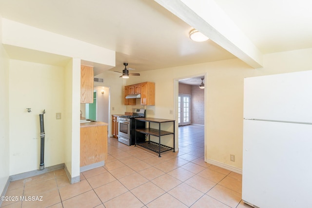 325 W Santa Maria St, Tucson, AZ 85706 - kitchen featuring freestanding refrigerator, stainless steel gas range oven, ceiling fan, under cabinet range hood, and light tile patterned floors