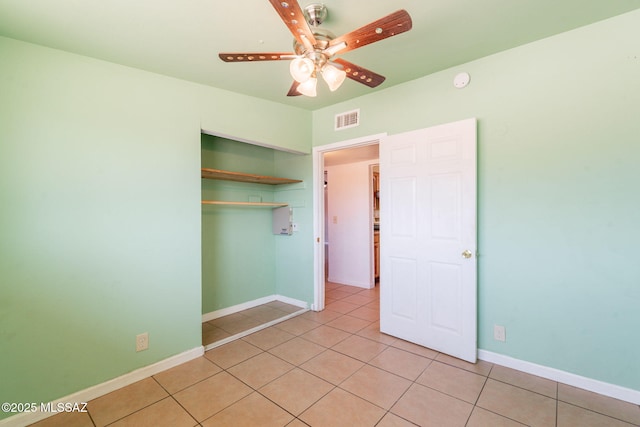 325 W Santa Maria St, Tucson, AZ 85706 - unfurnished bedroom with light tile patterned floors, a closet, and a ceiling fan