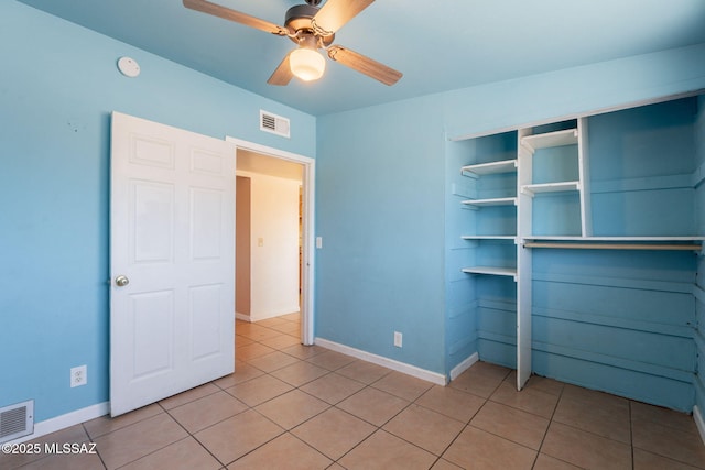 325 W Santa Maria St, Tucson, AZ 85706 - unfurnished bedroom featuring light tile patterned flooring, a closet, and a ceiling fan
