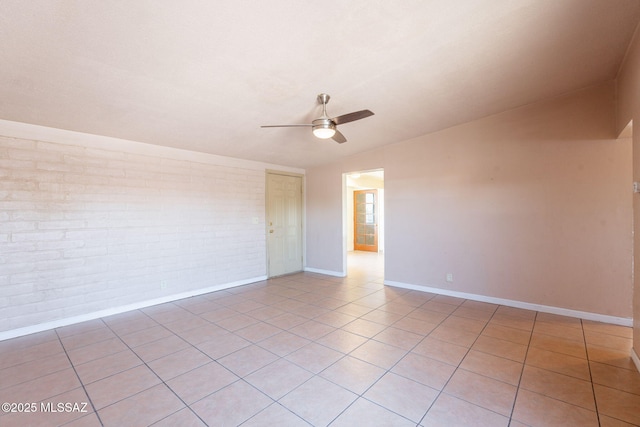 325 W Santa Maria St, Tucson, AZ 85706 - spare room featuring brick wall, ceiling fan, vaulted ceiling, and light tile patterned floors