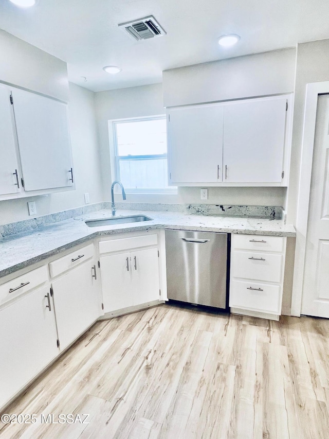 1105 S 1st Ave, Safford, AZ 85546 - kitchen featuring dishwasher, white cabinetry, light wood-style flooring, and light stone counters