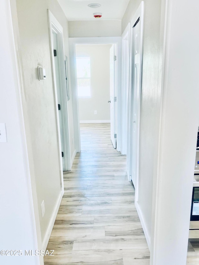 1105 S 1st Ave, Safford, AZ 85546 - hallway featuring baseboards and light wood finished floors