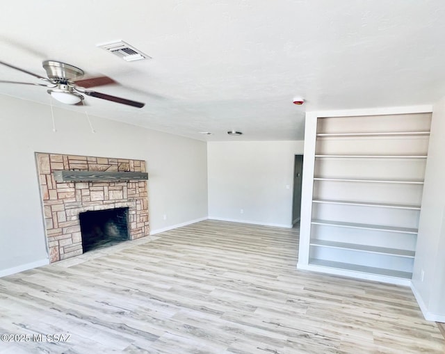 1105 S 1st Ave, Safford, AZ 85546 - unfurnished living room with ceiling fan, wood finished floors, and a fireplace