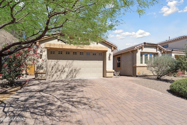 8470 N Gaetano Loop, Tucson, AZ 85742 - view of front of property featuring stucco siding, decorative driveway, and an attached garage