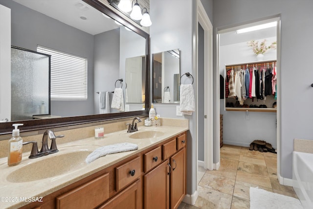 8470 N Gaetano Loop, Tucson, AZ 85742 - full bathroom featuring double vanity, a spacious closet, a bath, an enclosed shower, and stone finish flooring