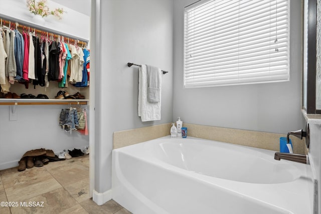 8470 N Gaetano Loop, Tucson, AZ 85742 - full bath with a bath, a spacious closet, stone finish floors, and plenty of natural light