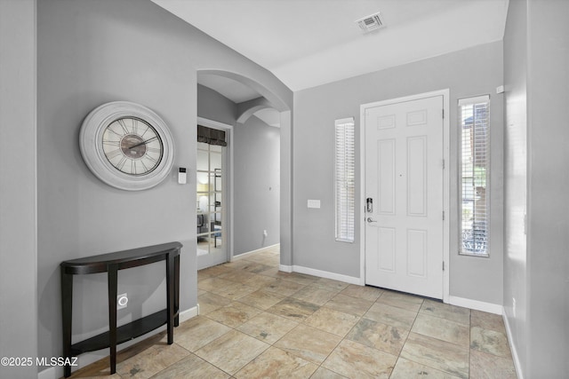8470 N Gaetano Loop, Tucson, AZ 85742 - foyer featuring arched walkways, stone finish floors, and lofted ceiling