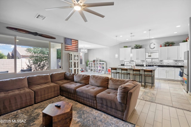 8470 N Gaetano Loop, Tucson, AZ 85742 - living area featuring ceiling fan, a chandelier, vaulted ceiling, and recessed lighting