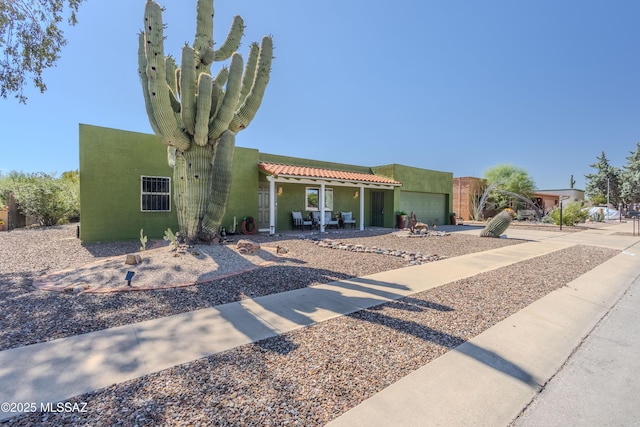 1120 N La Canoa, Green Valley, AZ 85614 - pueblo-style house featuring a garage, stucco siding, and driveway