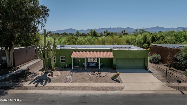 1120 N La Canoa, Green Valley, AZ 85614 - view of front facade featuring an attached garage, concrete driveway, stucco siding, and a tile roof
