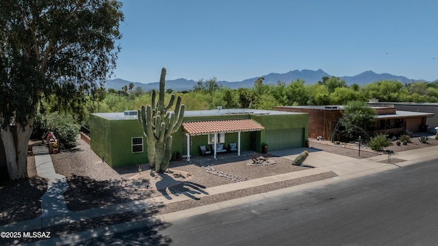 1120 N La Canoa, Green Valley, AZ 85614 - view of front of house with an attached garage, driveway, a mountain view, stucco siding, and a tiled roof