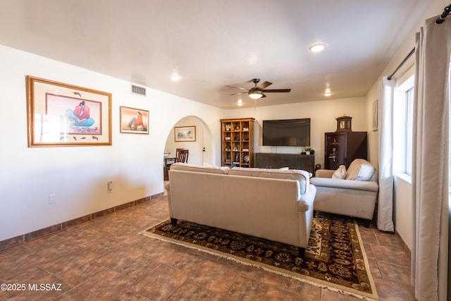 1120 N La Canoa, Green Valley, AZ 85614 - living area featuring arched walkways, ceiling fan, recessed lighting, and dark stone finish flooring