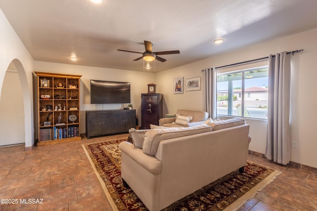 1120 N La Canoa, Green Valley, AZ 85614 - living area with ceiling fan, stone finish floors, and arched walkways