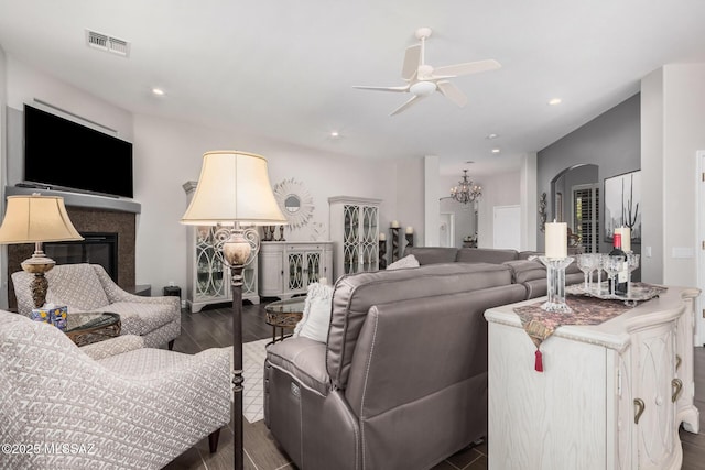 5371 W Leatherflower Ln, Marana, AZ 85658 - living area featuring a ceiling fan, a chandelier, wood finished floors, a glass covered fireplace, and recessed lighting