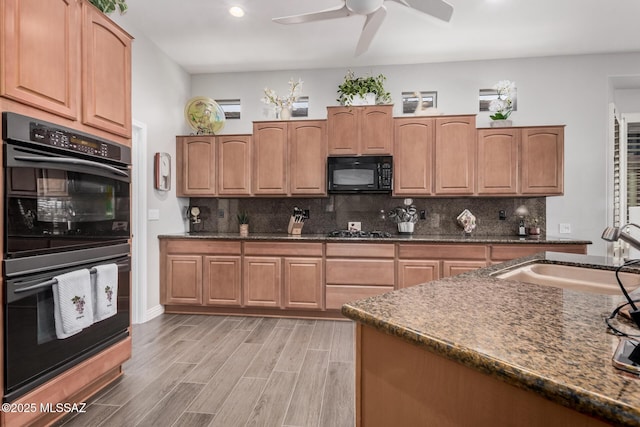 5371 W Leatherflower Ln, Marana, AZ 85658 - kitchen with black appliances, a ceiling fan, decorative backsplash, light wood finished floors, and dark stone countertops